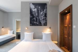 Llit o llits en una habitació de Hotel Lucca