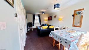 a room with a dining table and a living room at Lighthouse Apartment - Part of the The Bay Filey Holiday Village with pool, gym and direct beach access, pub, restaurant, tennis and meadows walks in Filey +42 photos