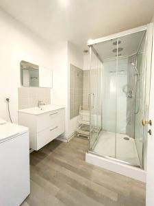 a white bathroom with a shower and a sink at Les Soeurs · Vue cathédrale · Chartres centre in Chartres