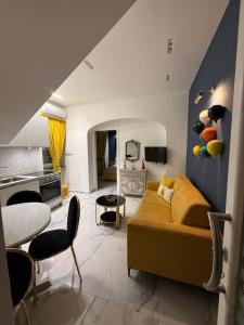a living room with a bed and a dining room at Frida Kahlo appartament in Lacco Ameno