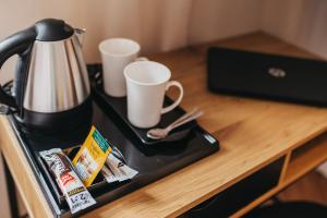 a counter with two cups on a tray on a table at Apartamenty Boutique 9 Sosnowiec in Sosnowiec