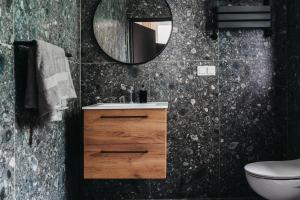 a bathroom with a sink and a mirror at Apartamenty Boutique 9 Sosnowiec in Sosnowiec
