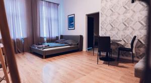 a living room with a bed and a table in it at Apartamenty Boutique 9 Sosnowiec in Sosnowiec