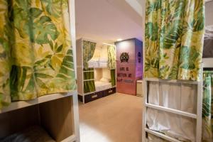 a small room with a bed and a room with curtains at Gijon Surf Hostel in Gijón +69 photos