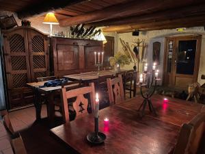 a dining room with a table with candles on it at La Lobio in Molines-en-Queyras