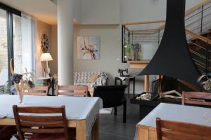 a living room with a table and chairs and a couch at Kerlenn in Baden