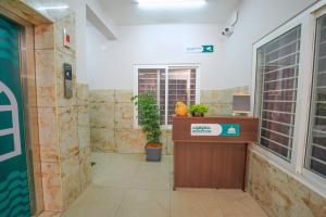 an office with a reception desk in a room at Veedu and Co Greens in Cochin