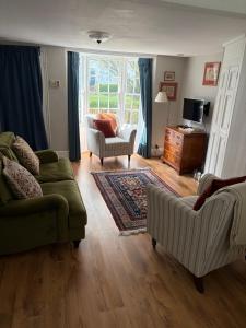 a living room with two couches and a television at 2 Bed Georgian cottage, Ramsgate in Ramsgate