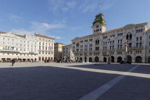 a large building with a clock tower on top of it at Bilocale in centro a 1 minuto da Piazza Unità in Trieste