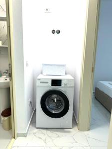 a washer and dryer in a small room at Taku Rooms Vlora in Vlorë +5 photos