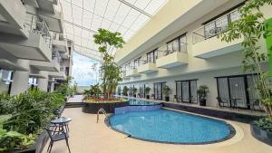 an indoor courtyard with a swimming pool in a building at Savana Hotel & Convention Malang in Malang