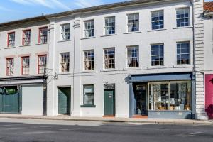 a white building on the corner of a street at The Library at The Merchants in Fenwick