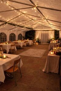 a large tent with tables and lights on it at Old Ridgeway Hotel in Chingford