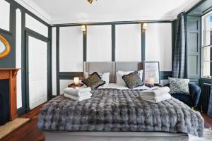 a bedroom with a large bed and a couch at The Library at The Merchants in Fenwick