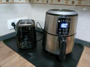 a slow cooker and a coffee maker on a counter at Apto 1 Hab, Terraza & Piscina, 5 min Playa in Playa de Gandia