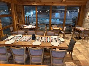 a dining room with a large wooden table and chairs at River Bridge in Žabljak
