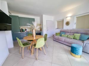 a living room with a table and chairs and a couch at Calypso Luxury Pool&Spa in Pula +17 photos