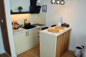 a kitchen with a counter with two cookies on it at Giorgio Luxury Suites in Belgrade