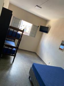 a bedroom with a bunk bed and a window at FIRMH HOSTEL CAFE DA MANHA incluso e traslado in Guarulhos +2 photos