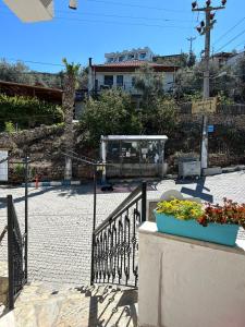 a fence with flowers in a pot on a street at Golden Pension in Patara +19 photos