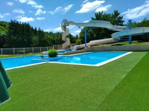 a large pool with a water slide in a park at Camping le Lizot - Mobil home 3 pièces 4/6 personnes + TV MAE-8684 in Saint-Mandé-sur-Brédoire