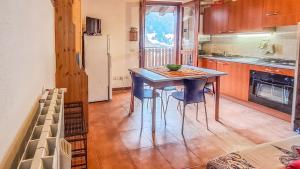 a kitchen with a table and chairs and a refrigerator at Casa Loca Colere in Colere +21 photos
