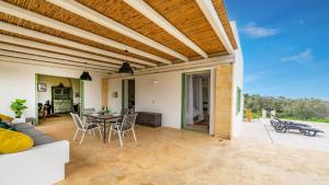 a large living room with a table and chairs at The Ridge House with Sea View by Rentbeat in Carovigno