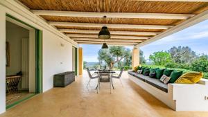 a living room with a couch and a table at The Ridge House with Sea View by Rentbeat in Carovigno