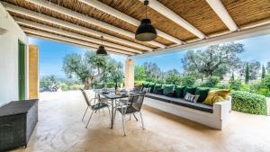 a living room with a couch and a table at The Ridge House with Sea View by Rentbeat in Carovigno +42 photos