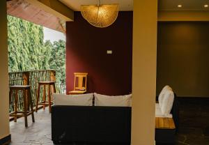 a room with a bed and a balcony at Explorers Kilimanjaro Boutique Hotel in Moshi