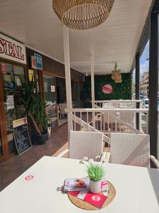 a table and chairs in front of a restaurant at Das Hostal in El Arenal