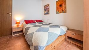 a bedroom with a bed with a checkered blanket at Casa Loca Colere in Colere