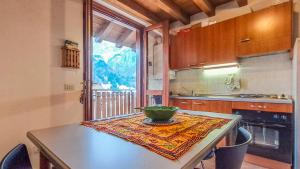 a kitchen with a table with a bowl on it at Casa Loca Colere in Colere
