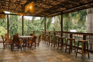 a dining room with tables and chairs on a balcony at Explorers Kilimanjaro Boutique Hotel in Moshi