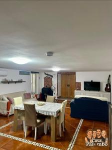 a living room with a table and a couch at Casa Palumbo in Bacoli