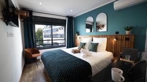 a bedroom with a large bed and a window at Maison le patio in Saint-Denis +17 photos