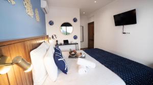 a bedroom with a bed with blue and white pillows at Maison le patio in Saint-Denis