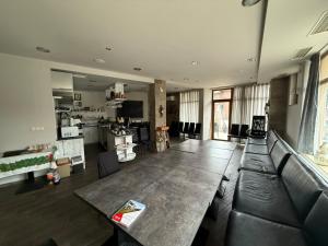 a large living room with a table and a couch at Roots Hotel Old Town in Plovdiv +56 photos