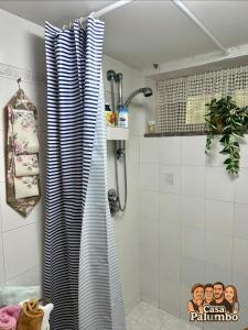 a bathroom with a shower curtain with a movie on it at Casa Palumbo in Bacoli +19 photos