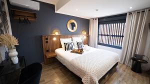 a bedroom with a white bed and a window at Maison le patio in Saint-Denis