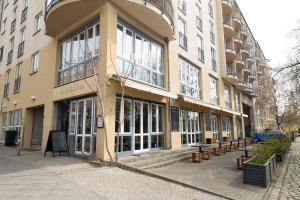 a large building with benches in front of it at Midi Inn Parkhotel Mitte in Berlin +7 photos