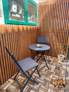 a table and a chair on a patio at Casa Palumbo in Bacoli