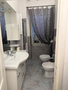 a bathroom with a sink and a toilet and a mirror at Affittacamere Casa Delle Rose in Antria