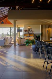 a lobby of a building with chairs and a couch at Hotel TorreMirona Golf & Spa in Figueres +66 photos