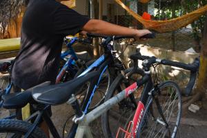 a man is standing next to two bikes at Bio Coliving Tayrona, Eco Retreat for You or Your group with Fast, Reliable WiFi & Power in Nature in Santa Marta