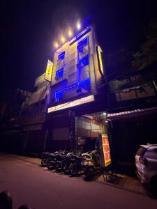 a row of motorcycles parked in front of a building at night at Hotel Park in Lucknow
