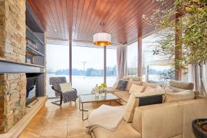 a living room with a couch and a fireplace at Stadel Lipno in Černá v Pošumaví