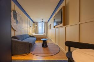 a living room with a couch and a table at CP Apartments San Mamés in Bilbao