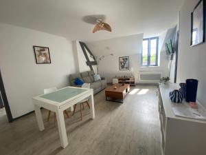 a living room with a table and a couch at chez Alain et Sylvie in Braine