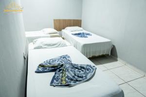 a group of three beds in a room at Dom Victor Residence Hotel in Goiânia +80 photos